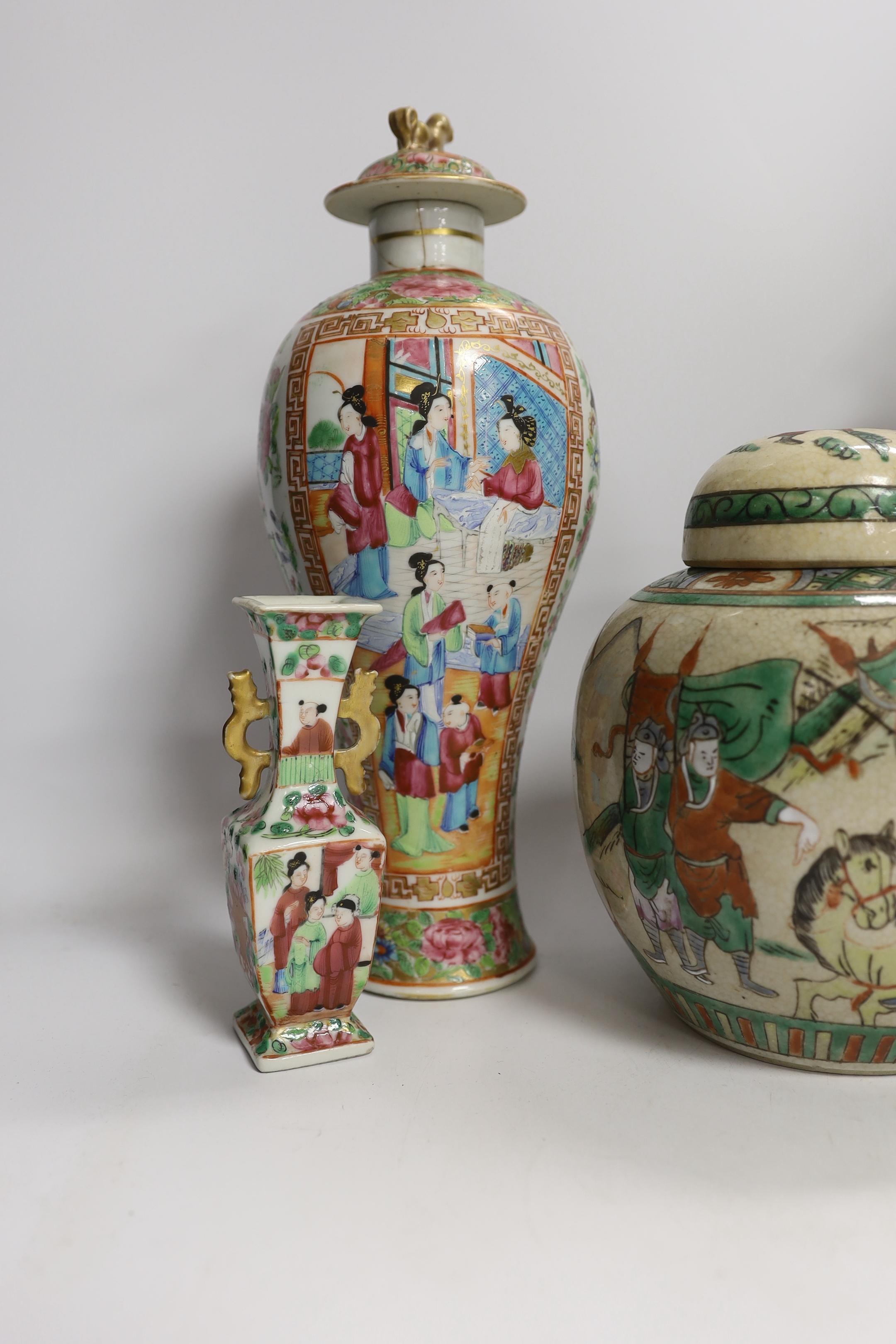 A pair of 19th century Chinese famille rose vases and covers, a similar small vase and a a famille verte crackle glaze jar, tallest 31cm